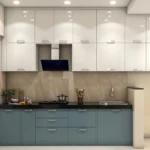 Desain dapur modern berbentuk L dengan kabinet putih mengkilap, unit bawah warna abu-abu biru, backsplash motif marmer, dan meja granit hitam